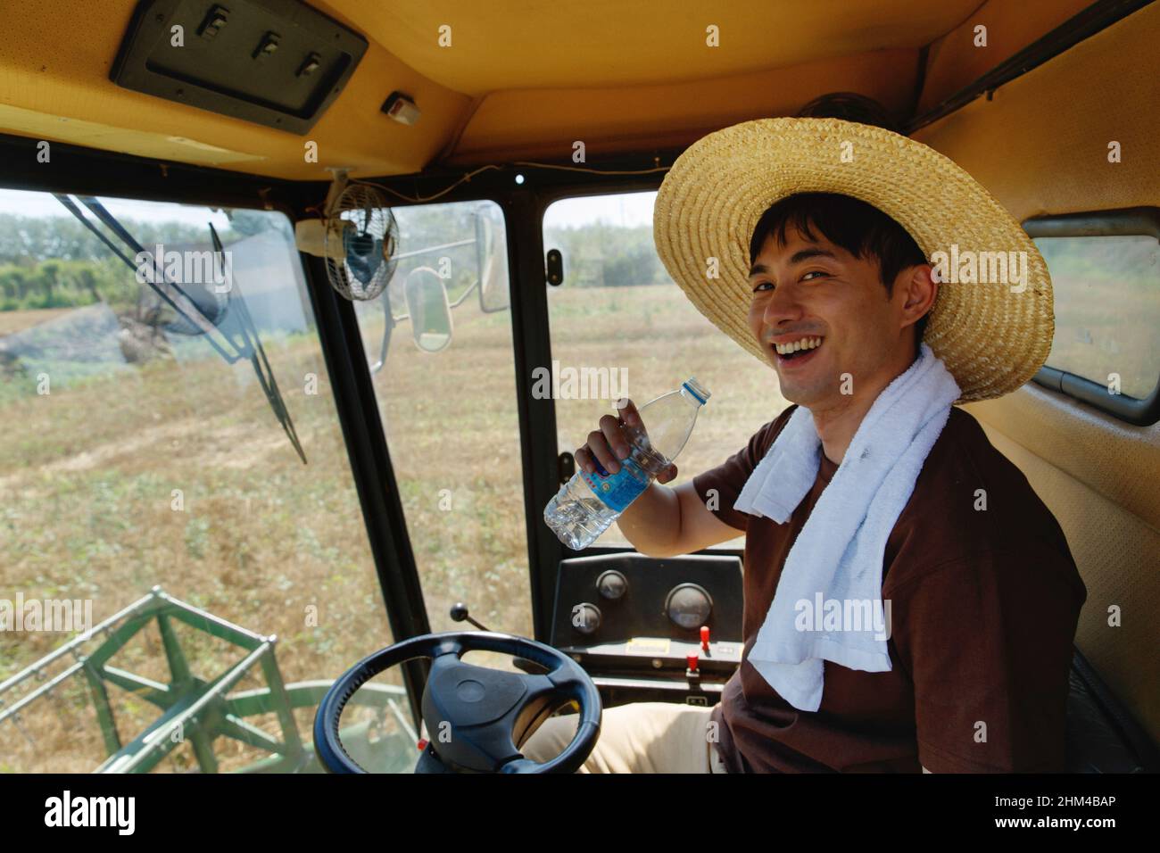 Farmers driving harvester Stock Photo