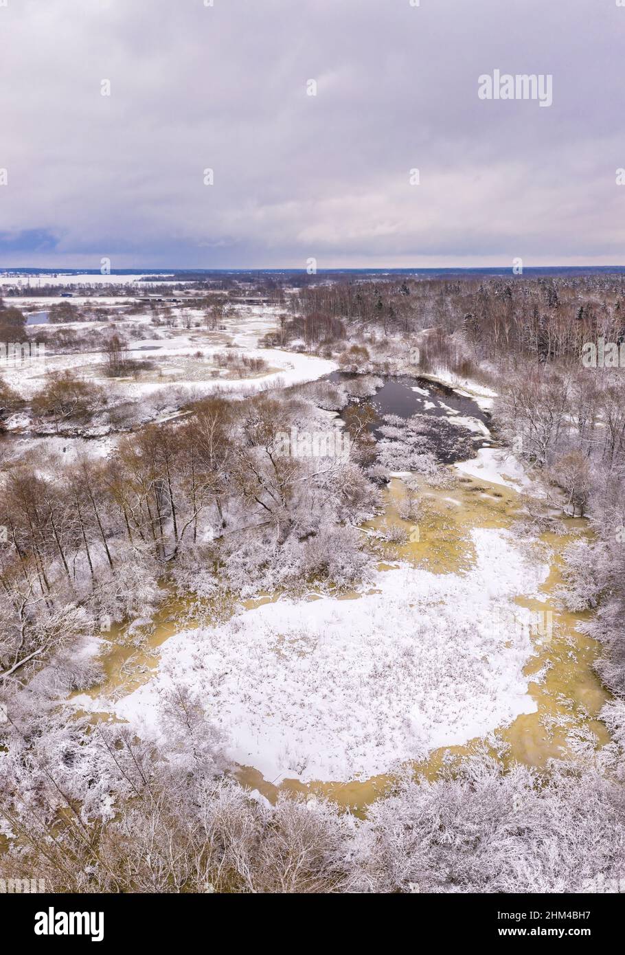 Rural winter lanscape. Aerial view on a river. River flowing through snow covered nature Stock Photo