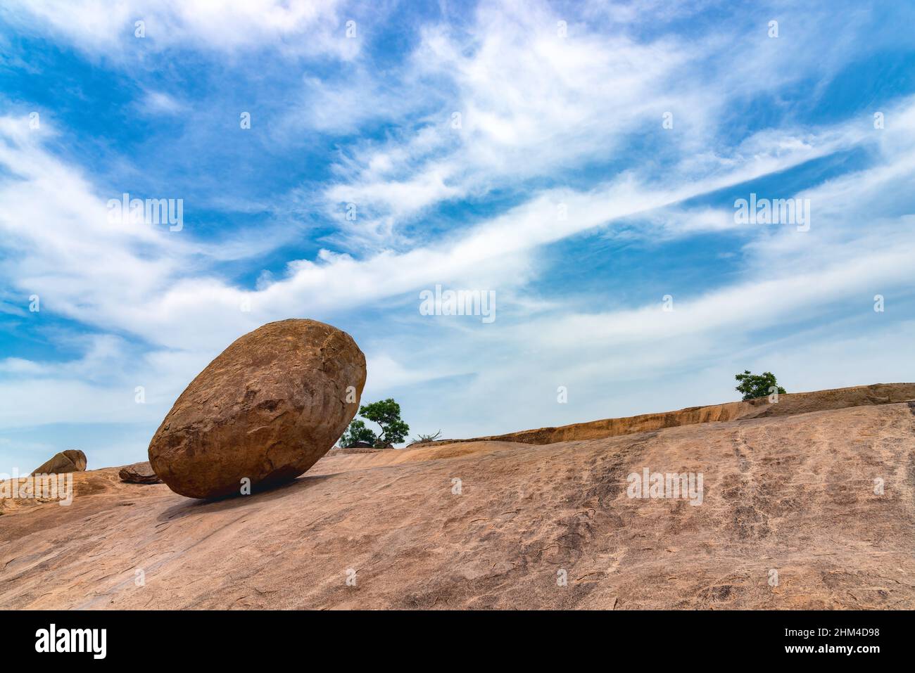 The Krishna's Butterball in Tamil Nadu, India.  This gigantic granite boulder resting on a short incline in the historical town of Mamallapuram Stock Photo