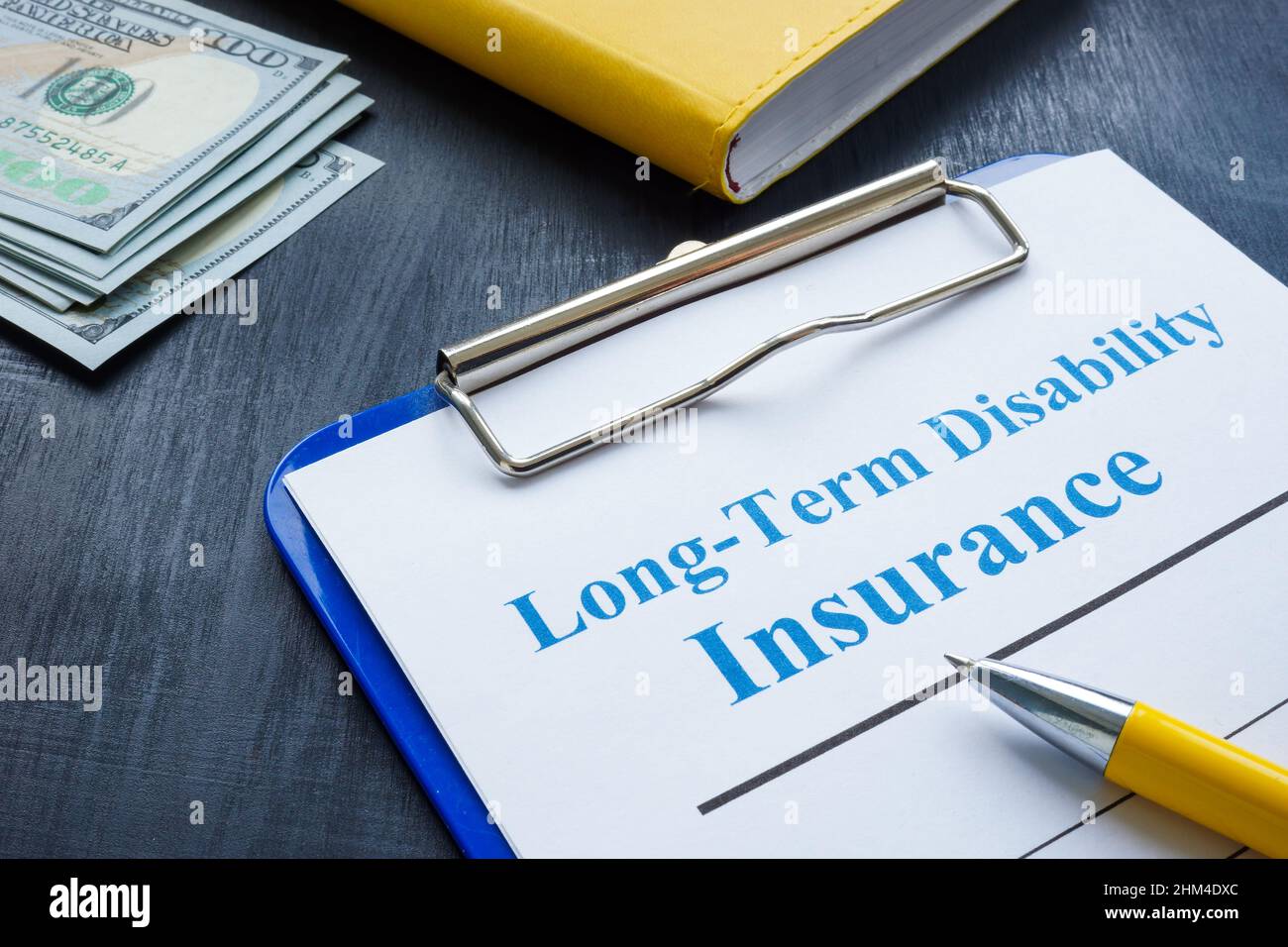 Long term disability insurance application and pen. Stock Photo