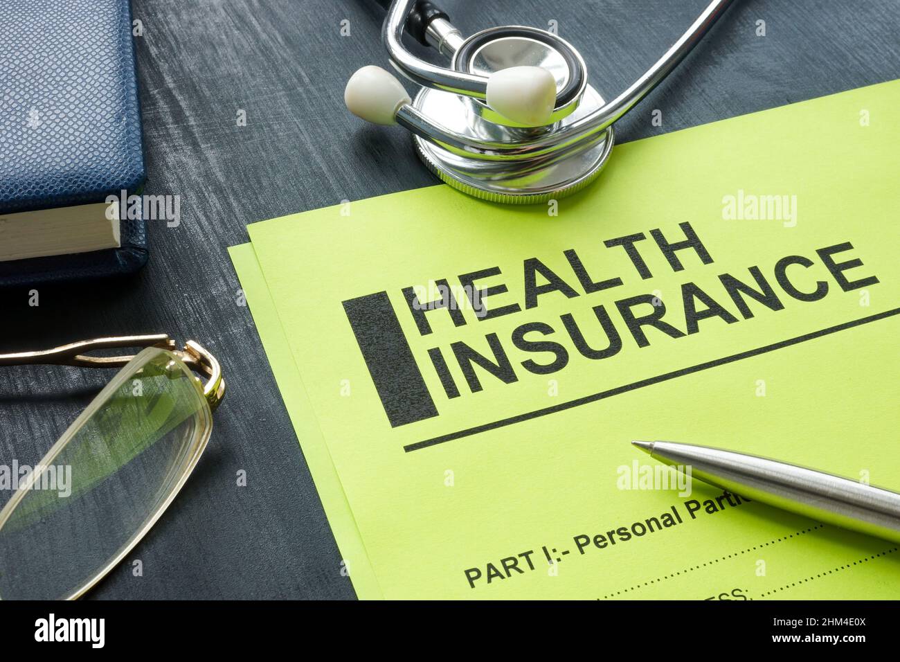 Health insurance form with stethoscope on the wooden surface. Stock Photo