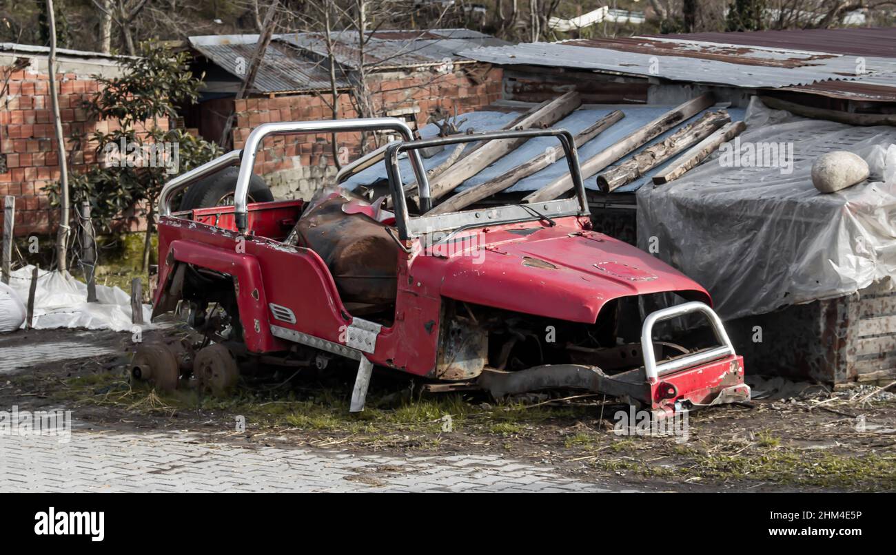 Wrecked vehicle, wrecked, junk, crashed, broken, totalled red SUV or car Stock Photo