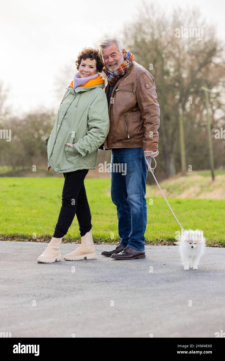 Senden, Germany. 30th Jan, 2022. Harry Wijnvoord, Dutch presenter ('The Price is Hot'), and his wife Iris Wijnvoord stand in front of their house with their dog, Bijou (4 months old), a dwarf spitz. Credit: Rolf Vennenbernd/dpa/Alamy Live News Stock Photo