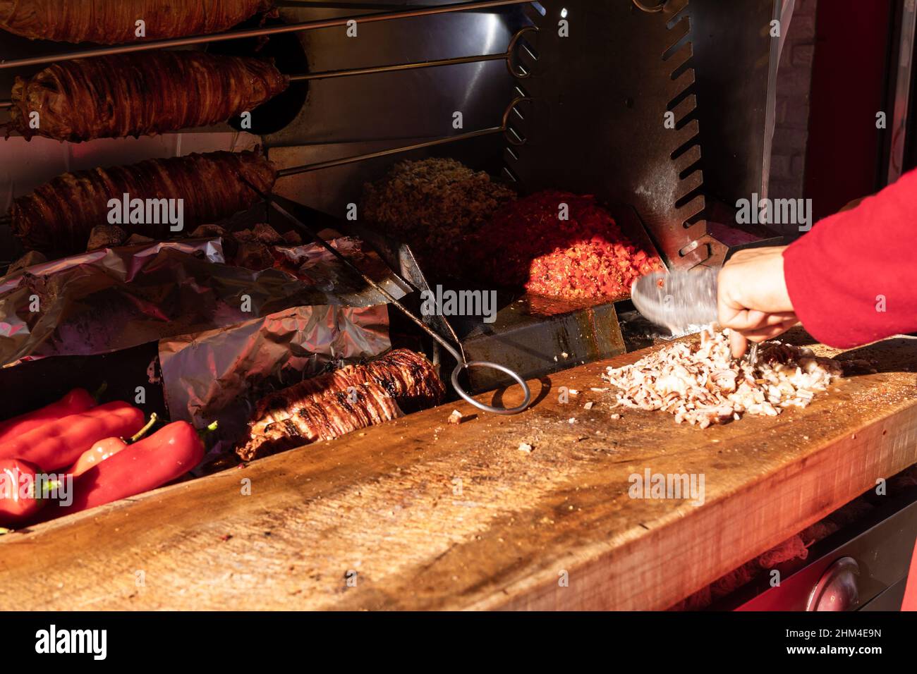 Chef chopping grilled lamb intestines making traditional turkish street food Kokorech (Kokorec) in Istanbul, Turkey Stock Photo