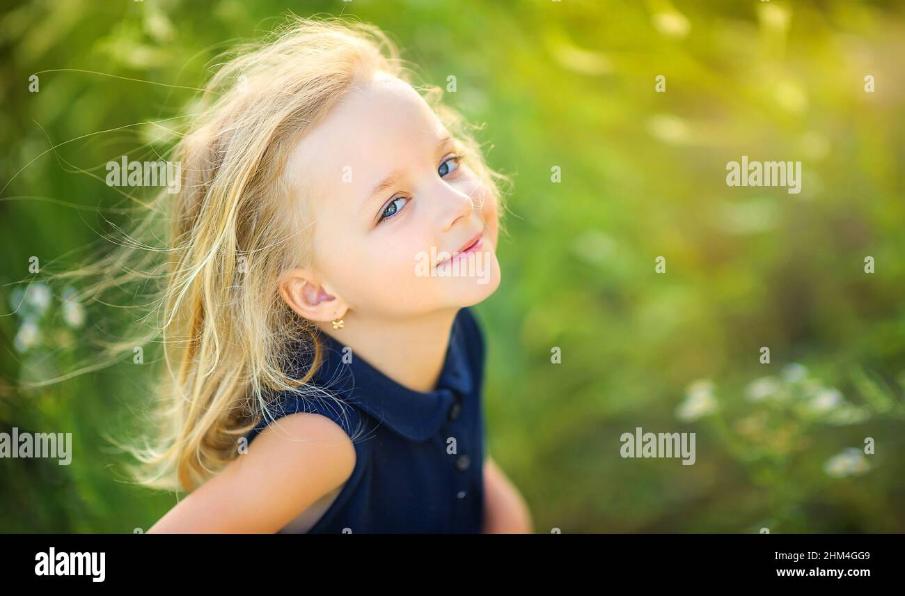 lovely cute little girl playing outdoors at sunset, walking and having fun, happy childhood Stock Photo