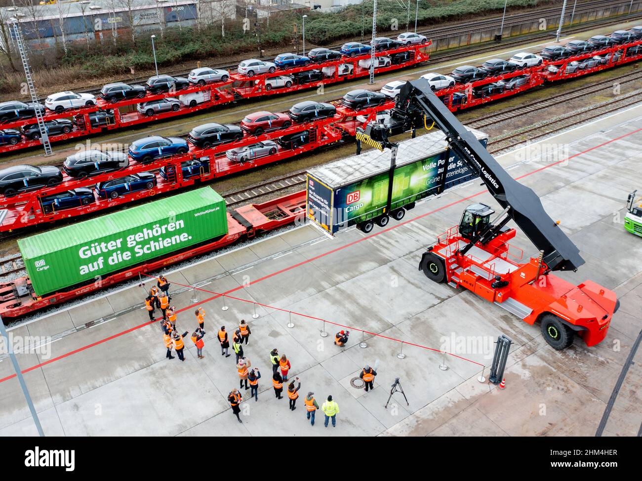 Bremen, Germany. 07th Feb, 2022. A so-called reach stacker lifts a trailer loaded with car batteries from a rail wagon on the DB Cargo site (aerial view with drone). The new Automotive Logistics Center on the DB Cargo rail site will be used in the future to transport drive batteries and vehicle components for electric vehicles from Mercedes-Benz at the Bremen plant. Credit: Hauke-Christian Dittrich/dpa/Alamy Live News Stock Photo
