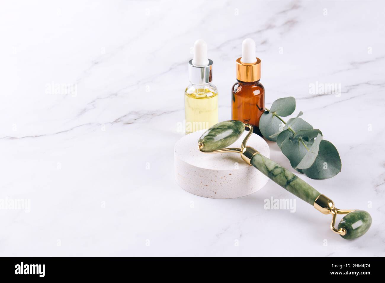 Jade facial roller and gua sha tool with beauty serum, face oil and
