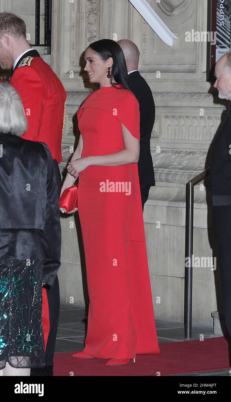 meghan markle and harry at the royal albert hall were he was wearing his army uniform as captain general for the last time.meghan looked very nice in that red dress and the said good bye to everyone before they speeded off to the palace 7/3/2020 Stock Photo