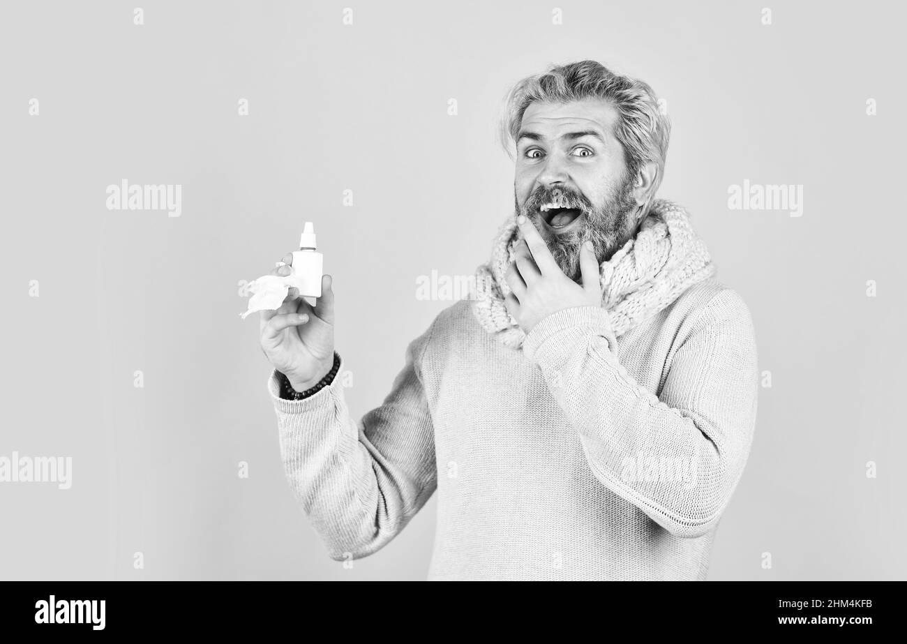 man use effective medicines. happy man hold nasal drops. It helps. Flu concept. hipster feels badly ill sneezing. Effective nasal spray. Runny nose Stock Photo