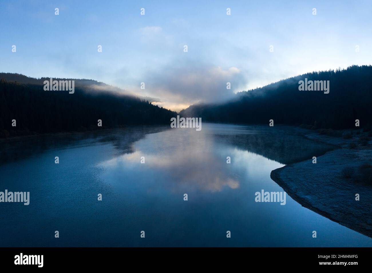 Aerial view of a misty lake. Dawn dark lights during sunrise, cold weather Stock Photo