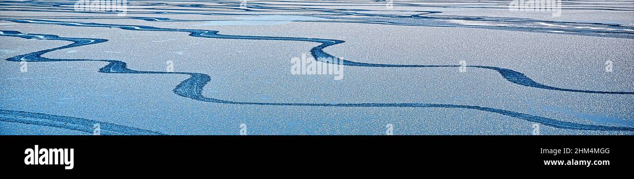 Bluewater surface texture with melting ice and ripples.  Abstract winter banner background Water waves in sunlight with copy space.  Natural pattern o Stock Photo