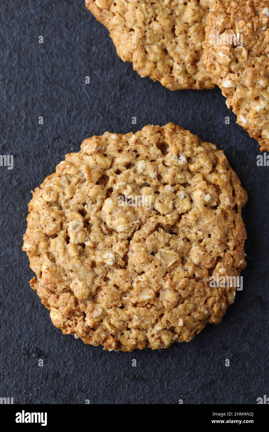 Homemade crunchy texture organic oat gluten free biscuit cookies on a dark background Stock Photo