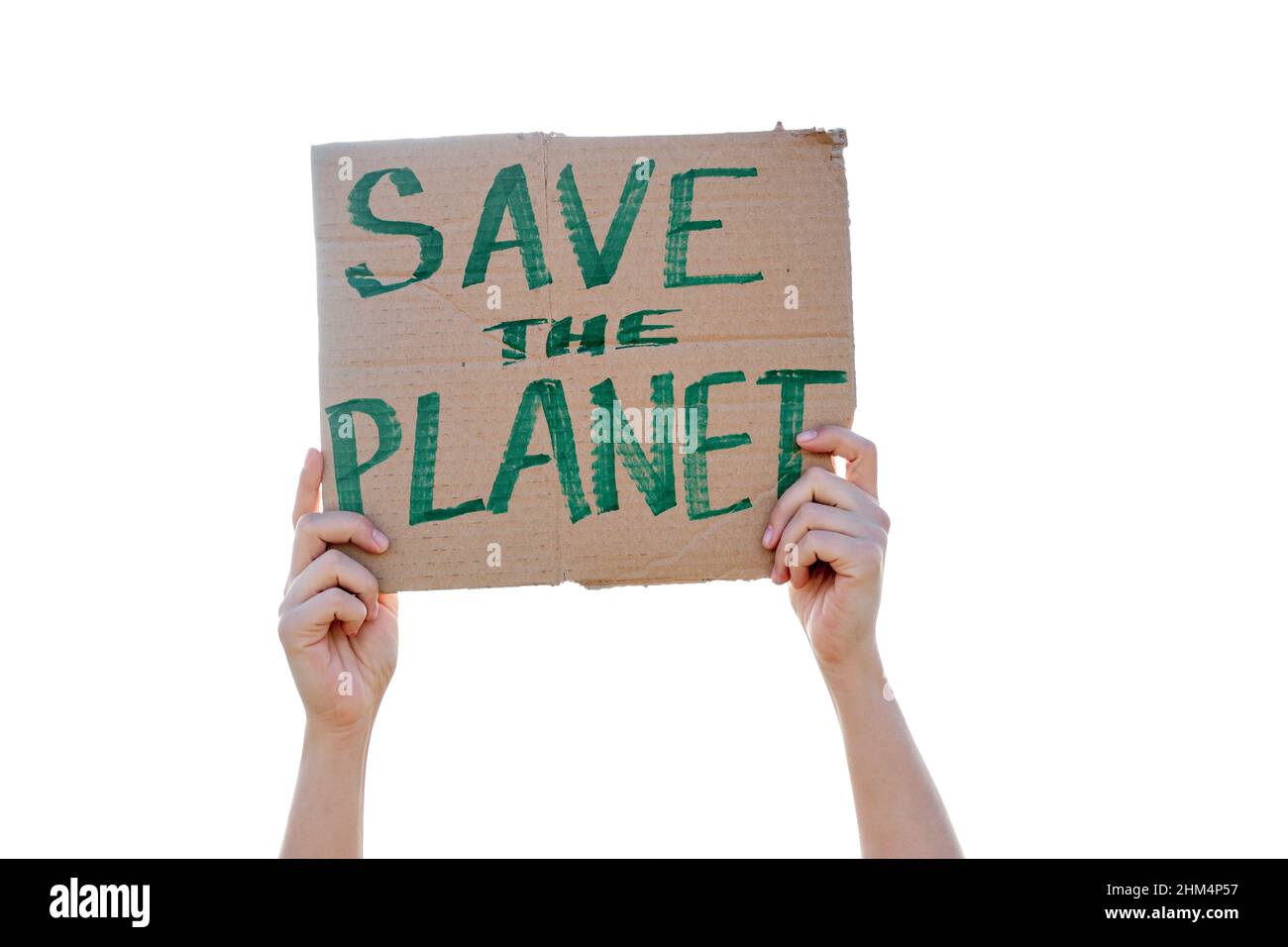 Woman's hand holding a cardboard sign that says SAVE THE PLANET Stock Photo