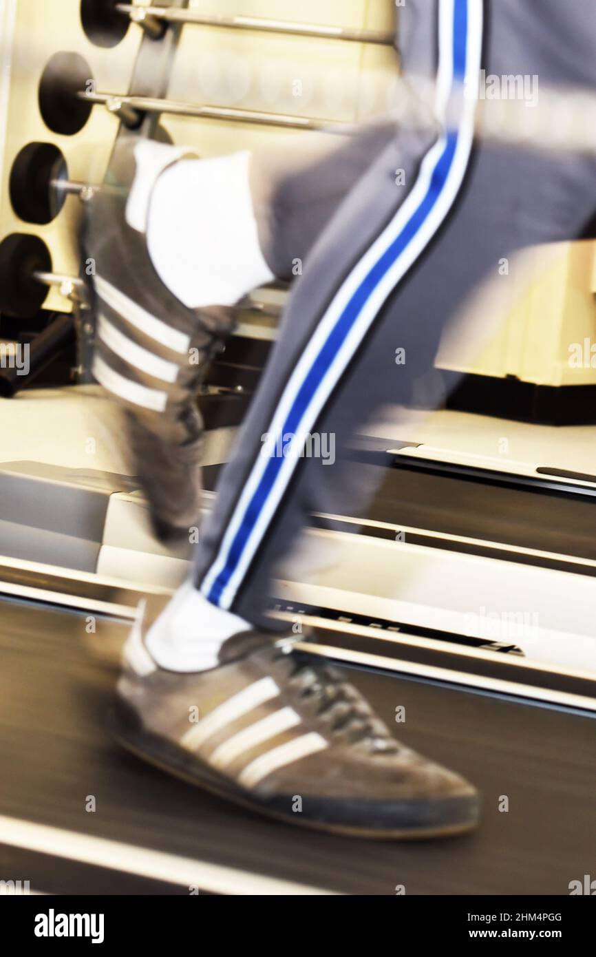 Feet running on a treadmill in a gym UK Stock Photo