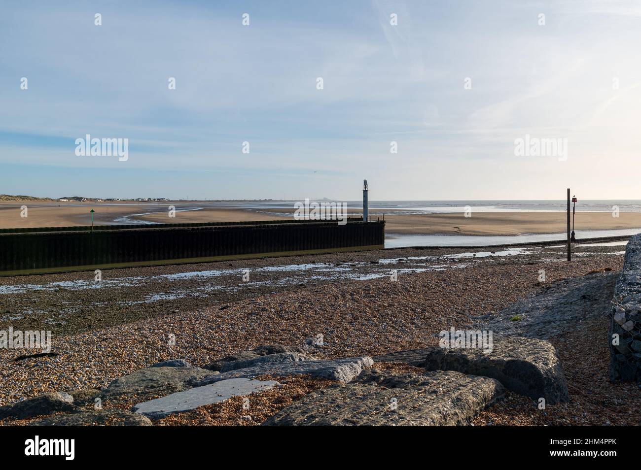 The entrance to Rye Harbour (River Rother) at low tide looking towards Camber Sands and showing the navigation beacons Stock Photo