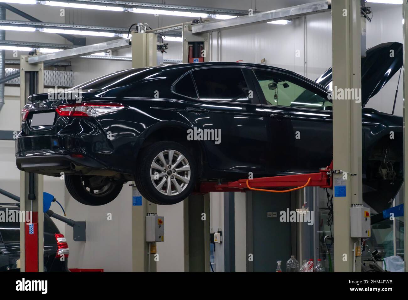 Dark blue car is lifted on a car lift in a service station Stock Photo ...