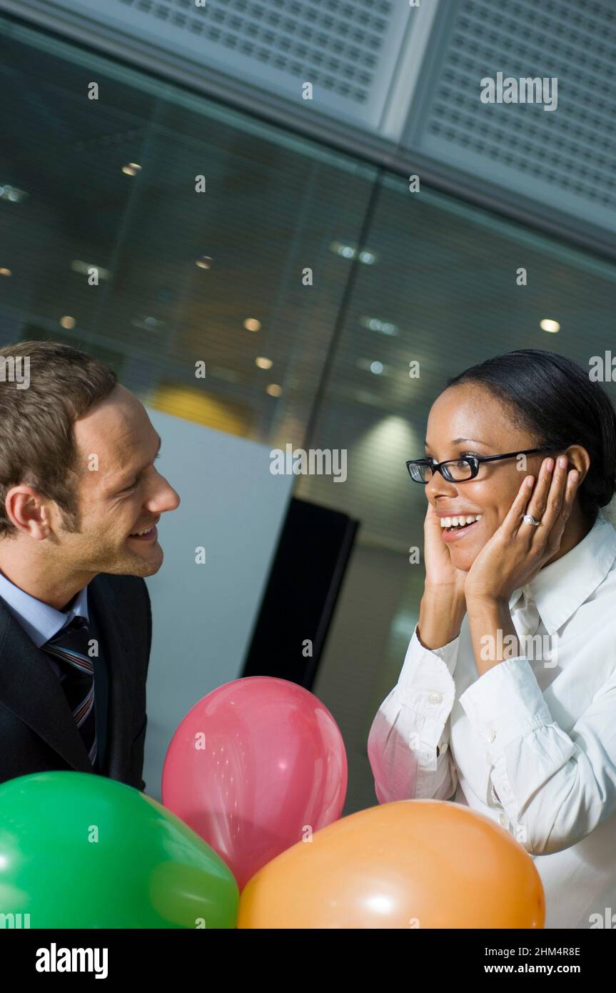 Side Profile Of A Businessman And A Businesswoman Looking At Each Other And Smiling, Credit:Photoshot Creative / Stuart Cox / Avalon Stock Photo