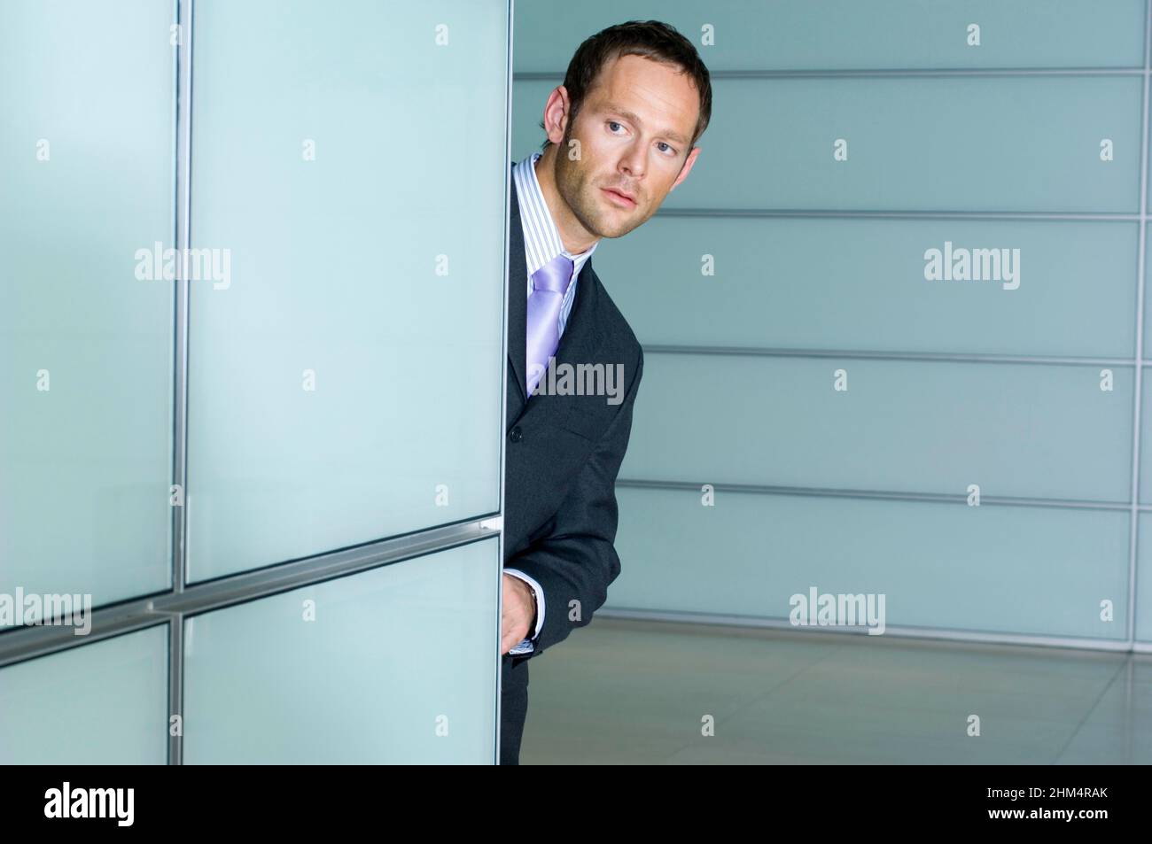 Businessman Looking Out From Behind A Wall, Credit:Photoshot Creative / Stuart Cox / Avalon Stock Photo