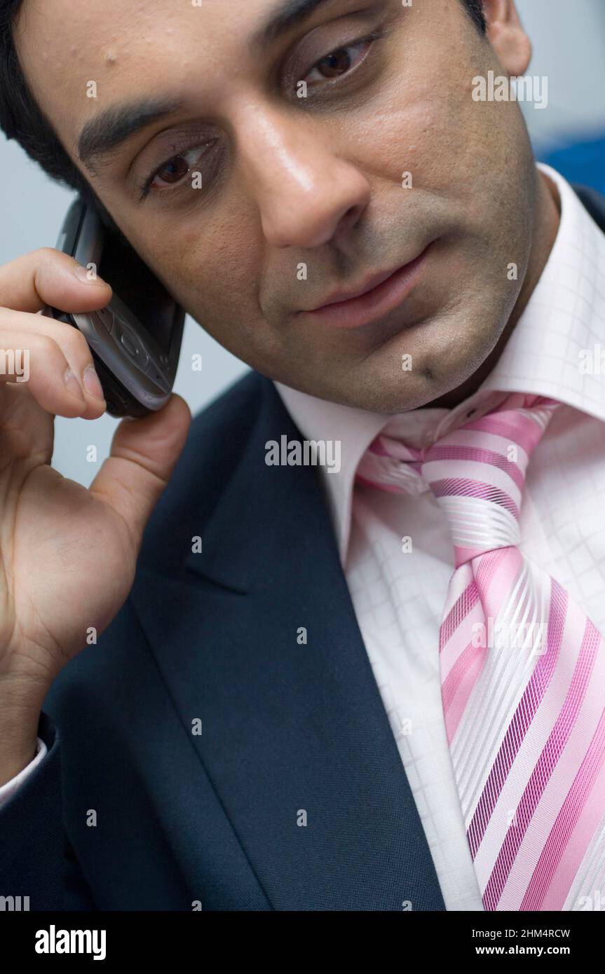 Close-Up Of A Businessman Talking On A Mobile Phone, Credit:Photoshot Creative / Stuart Cox / Avalon Stock Photo