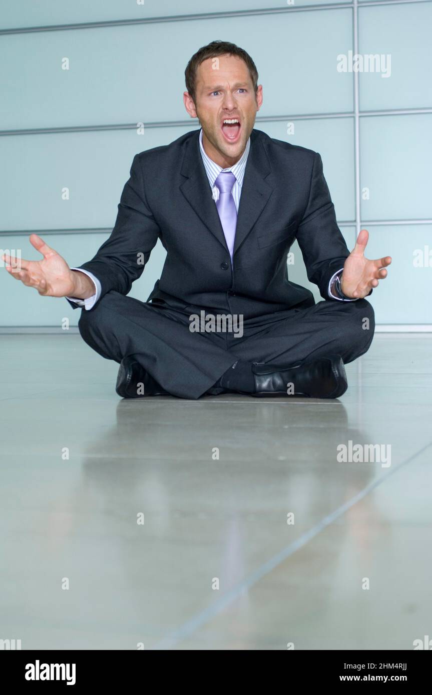 Businessman Sitting On The Floor And Shouting, Credit:Photoshot Creative / Stuart Cox / Avalon Stock Photo