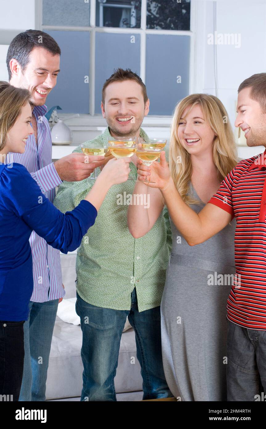 Three Young Men With Two Young Women Toasting Glasses Of Wine And Smiling, Credit:Photoshot Creative / Stuart Cox / Avalon Stock Photo