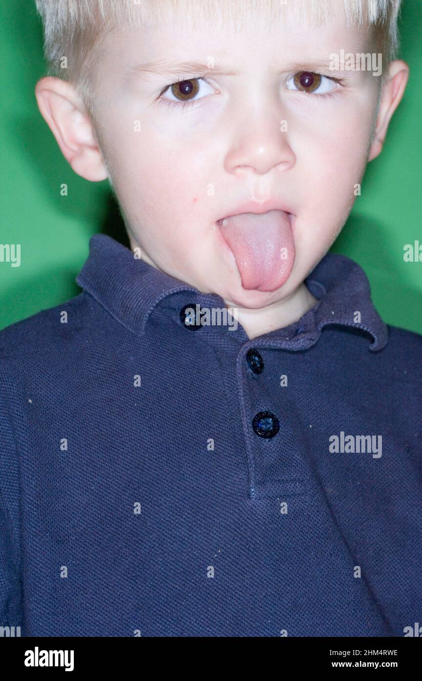 Portrait Of A Boy Sticking His Tongue Out, Credit:Photoshot Creative / Stuart Cox / Avalon Stock Photo