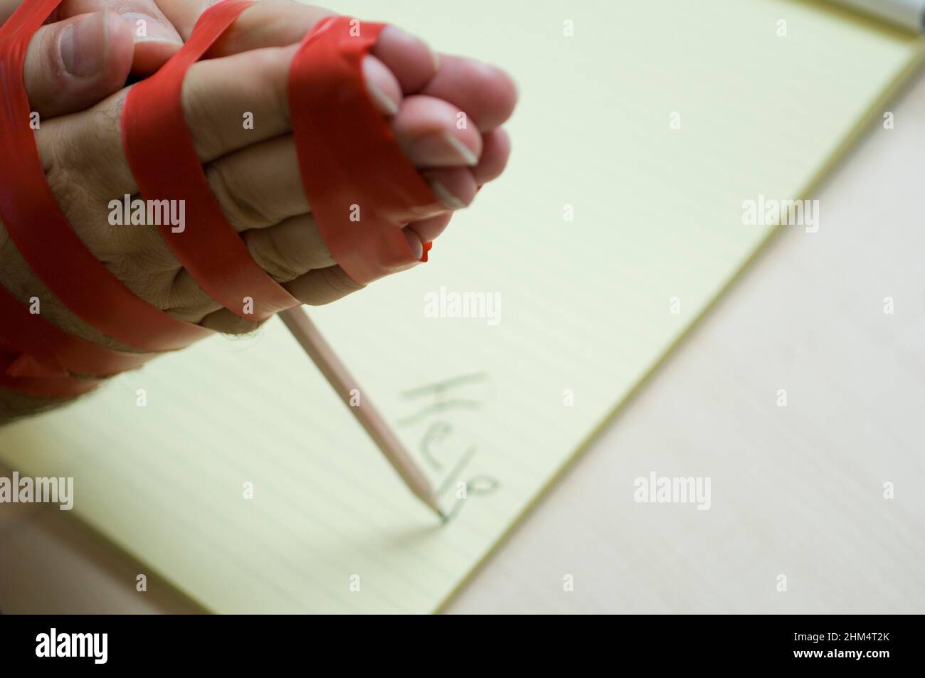 Close-Up Of A Person Hand'S Bound And Writing With A Pencil, Credit:Photoshot Creative / Stuart Cox / Avalon Stock Photo