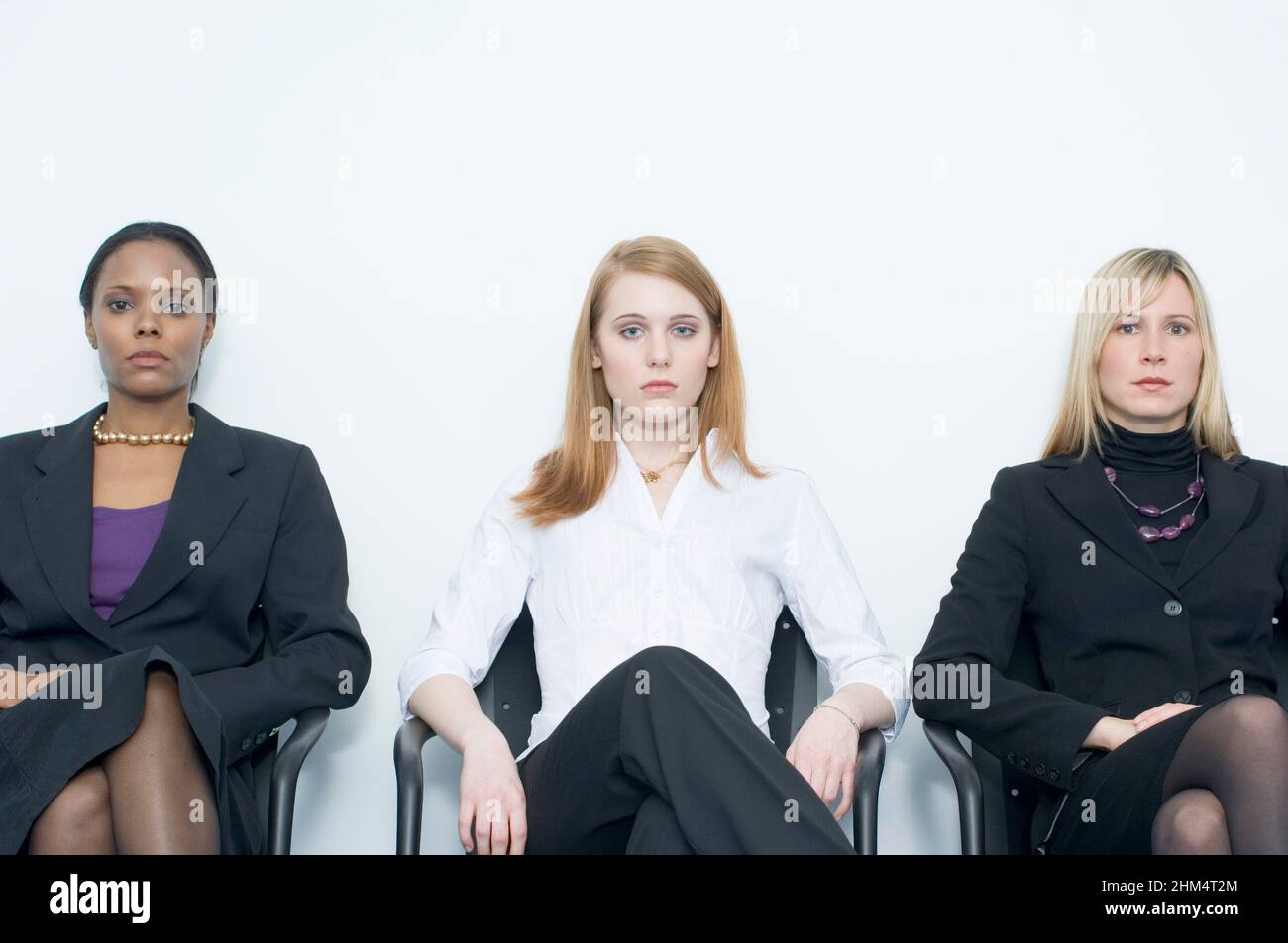 Portrait Of Three Businesswomen Sitting Side By Side, Credit:Photoshot Creative / Stuart Cox / Avalon Stock Photo