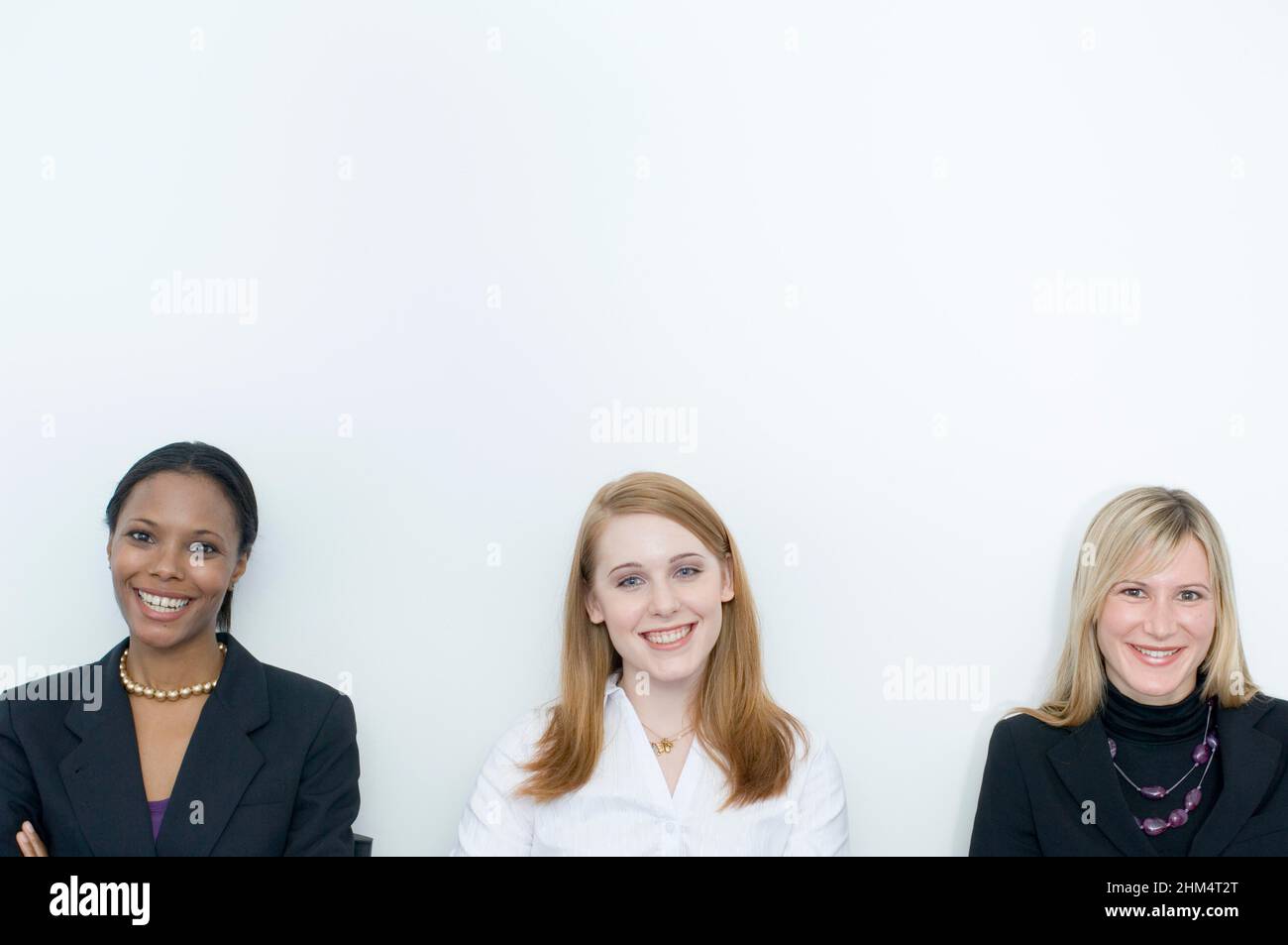 Portrait Of Three Businesswomen Smiling Side By Side, Credit:Photoshot Creative / Stuart Cox / Avalon Stock Photo