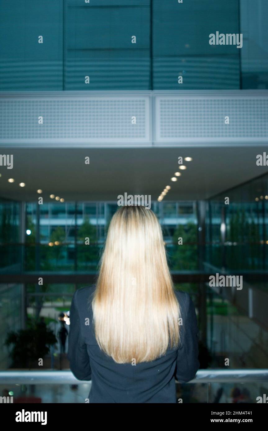 Rear View Of A Businesswoman Standing Near A Railing, Credit:Photoshot Creative / Stuart Cox / Avalon Stock Photo