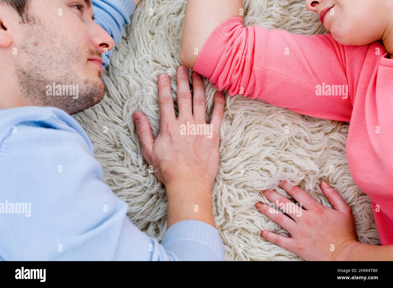Close-Up Of A Young Couple Laying On A Carpet, Credit:Photoshot Creative / Stuart Cox / Avalon Stock Photo