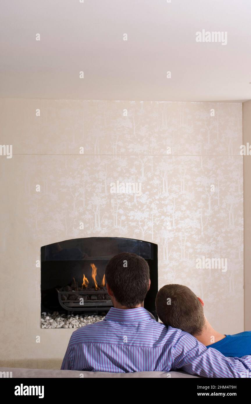 Rear View Of Two Men In Front Of A Fireplace, Credit:Photoshot Creative / Stuart Cox / Avalon Stock Photo