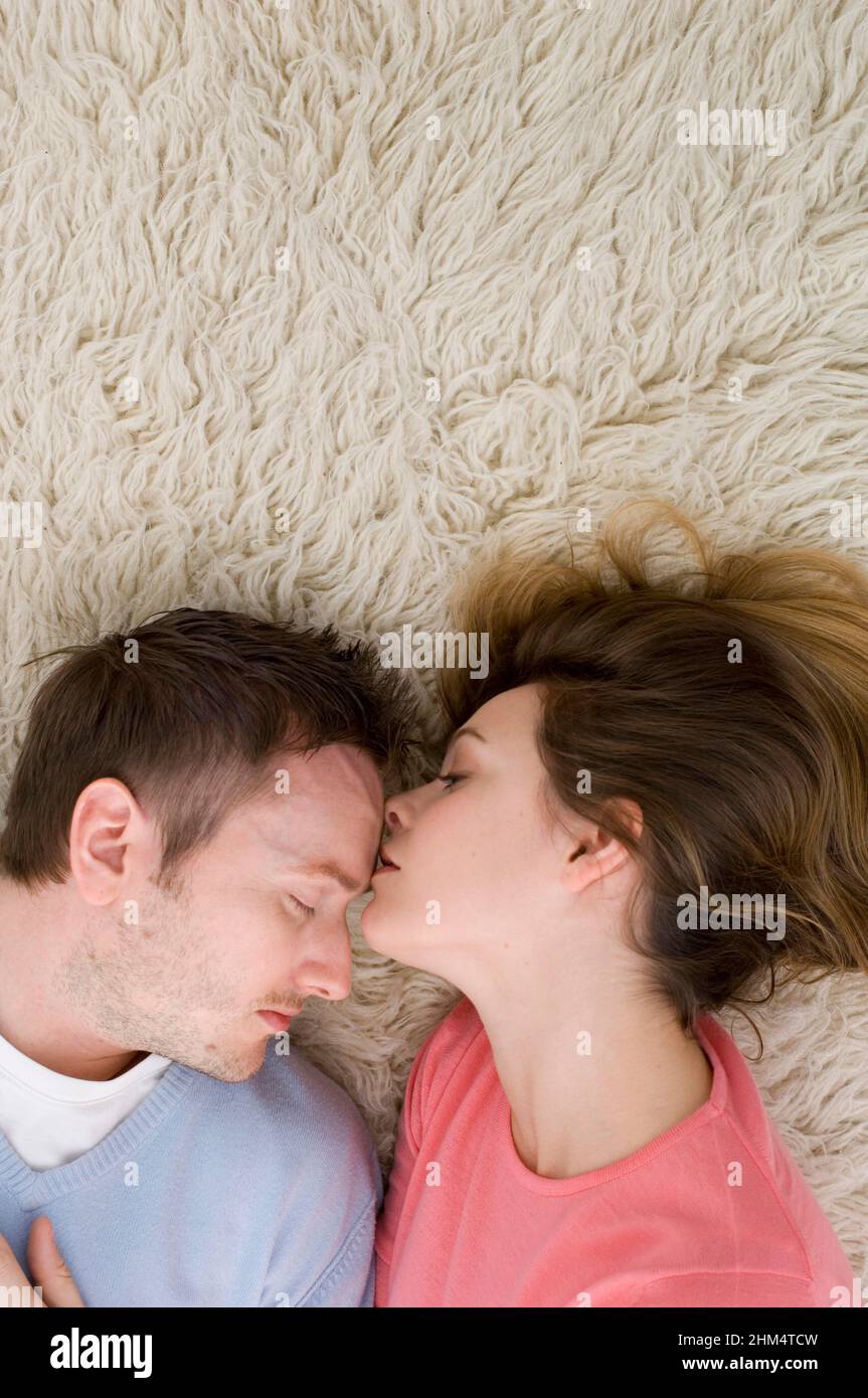 High Angle View Of A Young Couple Sleeping On A Rug, Credit:Photoshot Creative / Stuart Cox / Avalon Stock Photo