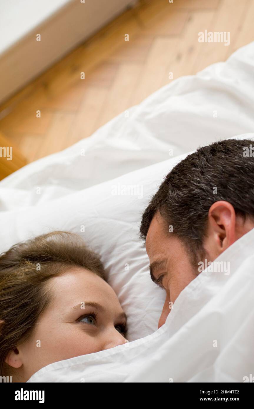 High Angle View Of A Young Couple Laying On The Bed And Looking At Each Other, Credit:Photoshot Creative / Stuart Cox / Avalon Stock Photo