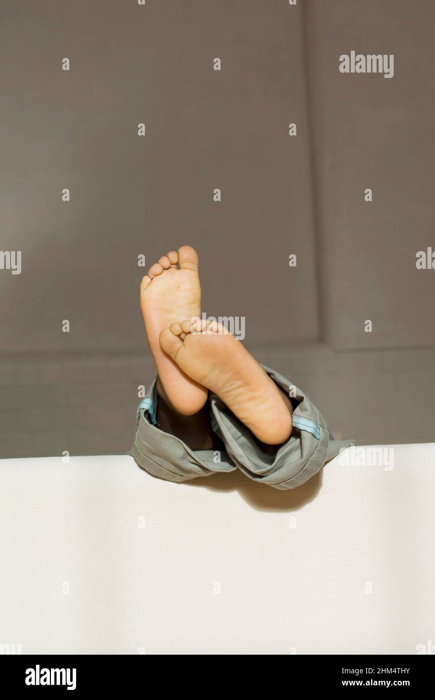 Close-Up Of A Child'S Feet On A Sofa Or Couch, Credit:Photoshot Creative / Stuart Cox / Avalon Stock Photo