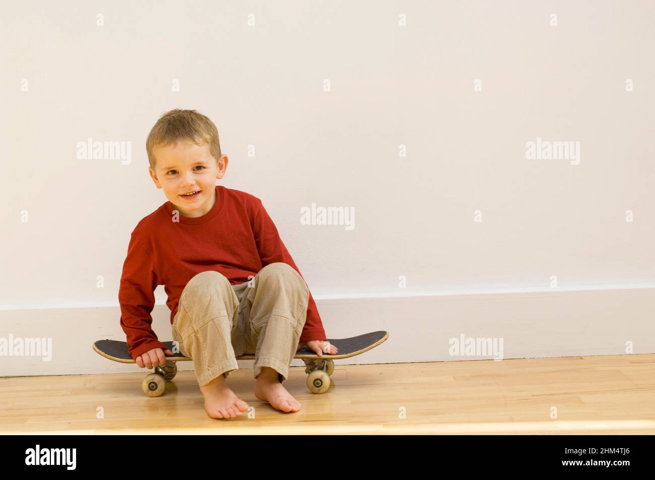 Portrait Of A Boy Sitting On A Skateboard, Credit:Photoshot Creative / Stuart Cox / Avalon Stock Photo