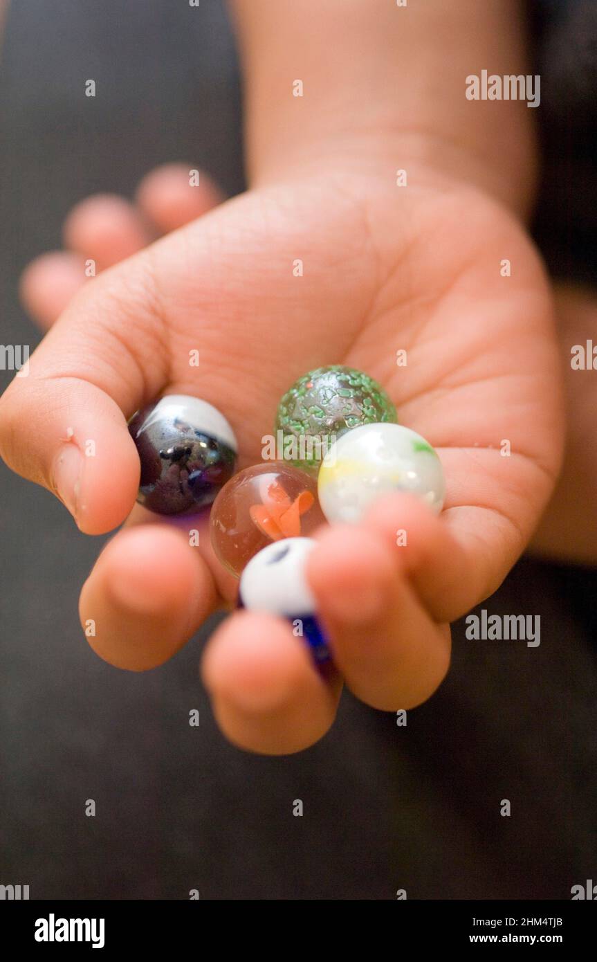Close-Up Of A Child'S Hand Showing Marbles, Credit:Photoshot Creative / Stuart Cox / Avalon Stock Photo