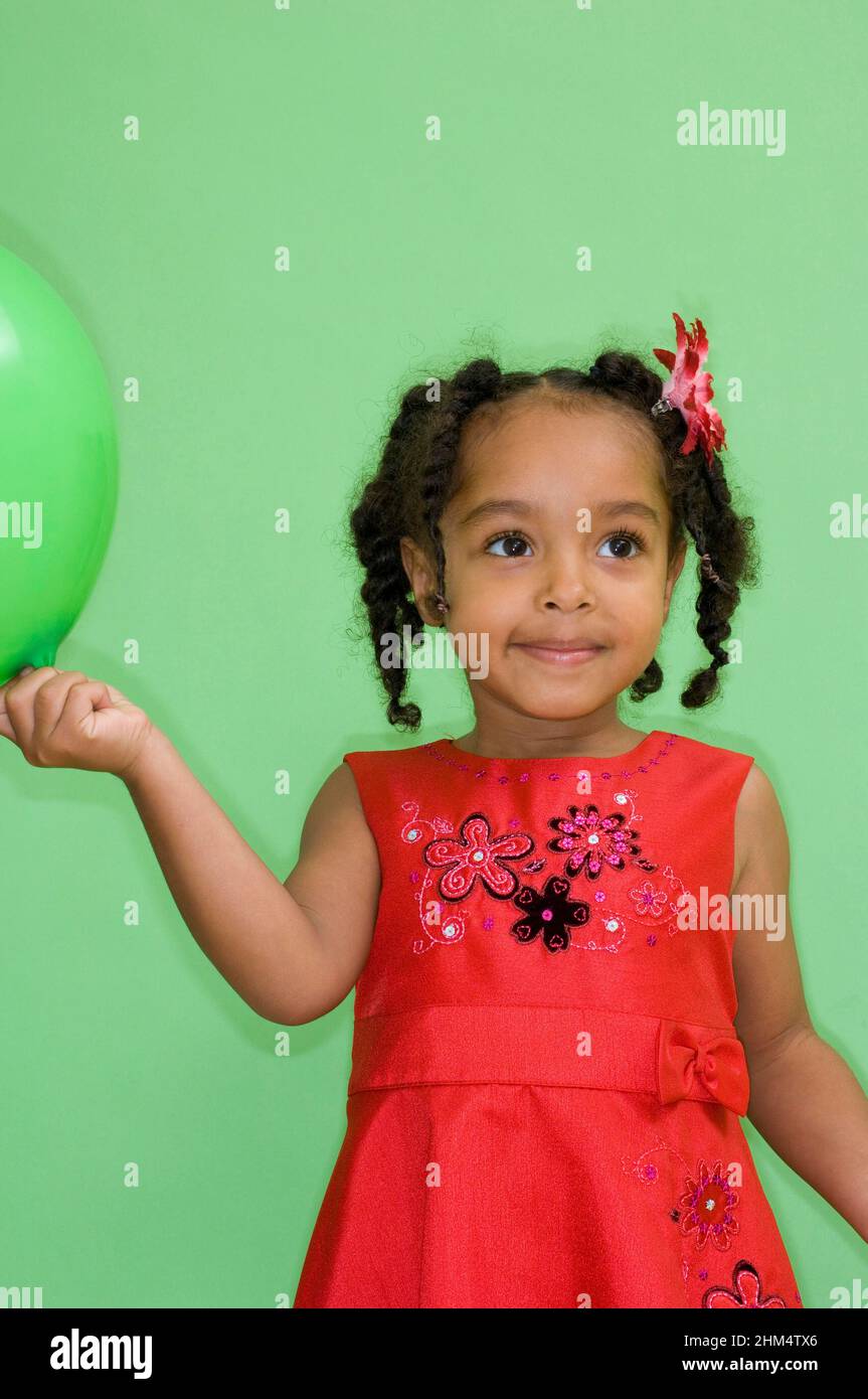 Close-Up Of A Girl Holding A Balloon And Looking Away, Credit:Photoshot Creative / Stuart Cox / Avalon Stock Photo
