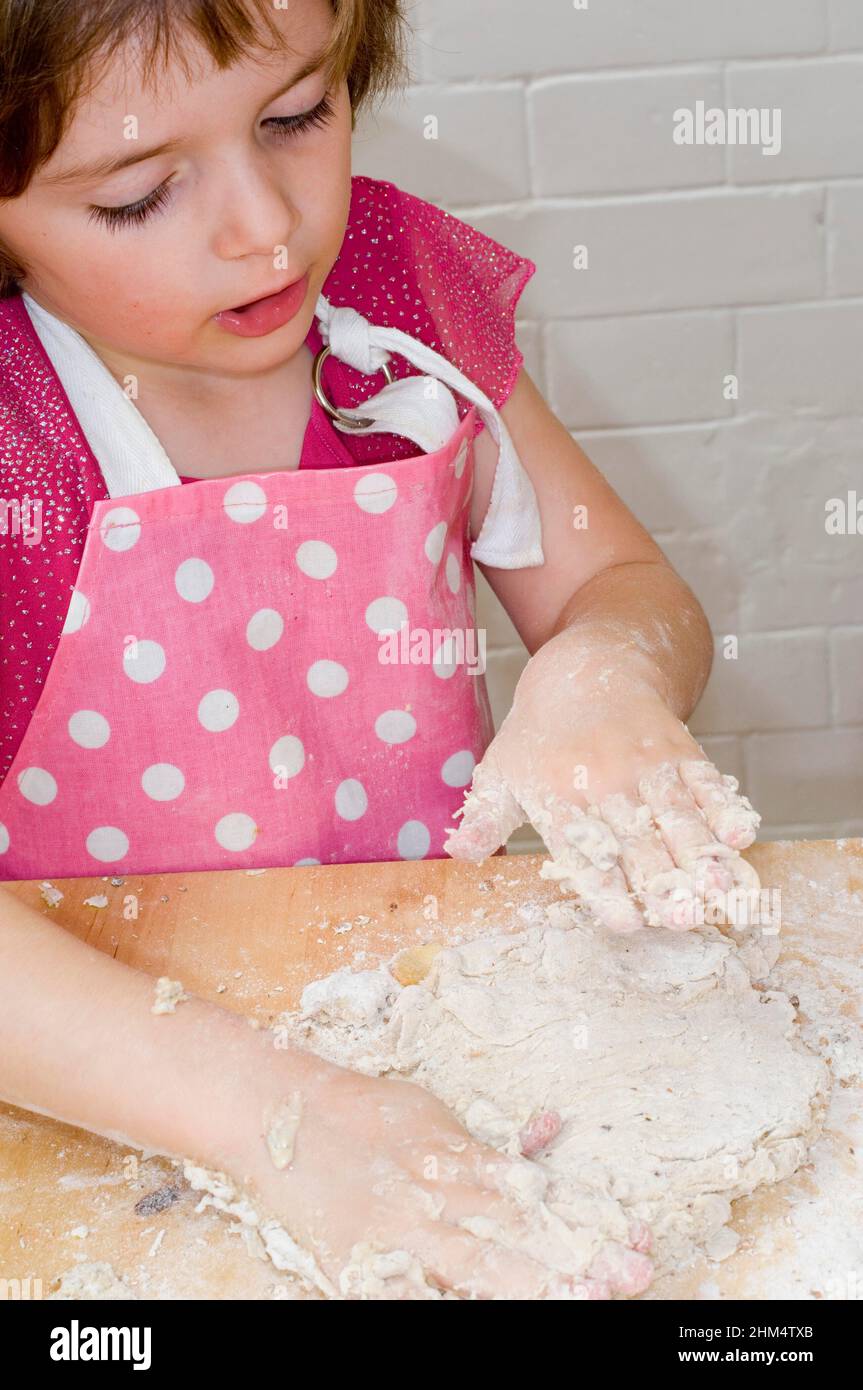 High Angle View Of A Girl Kneading Dough, Credit:Photoshot Creative / Stuart Cox / Avalon Stock Photo
