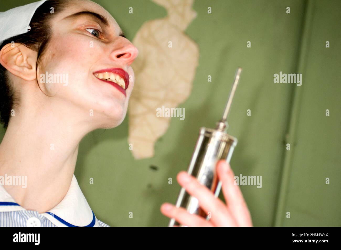 Head Shot Of Stylised Nurse In Uniform, Holding Syringe, Looking Evil., Credit:Photoshot Creative / Stuart Cox / Avalon Stock Photo