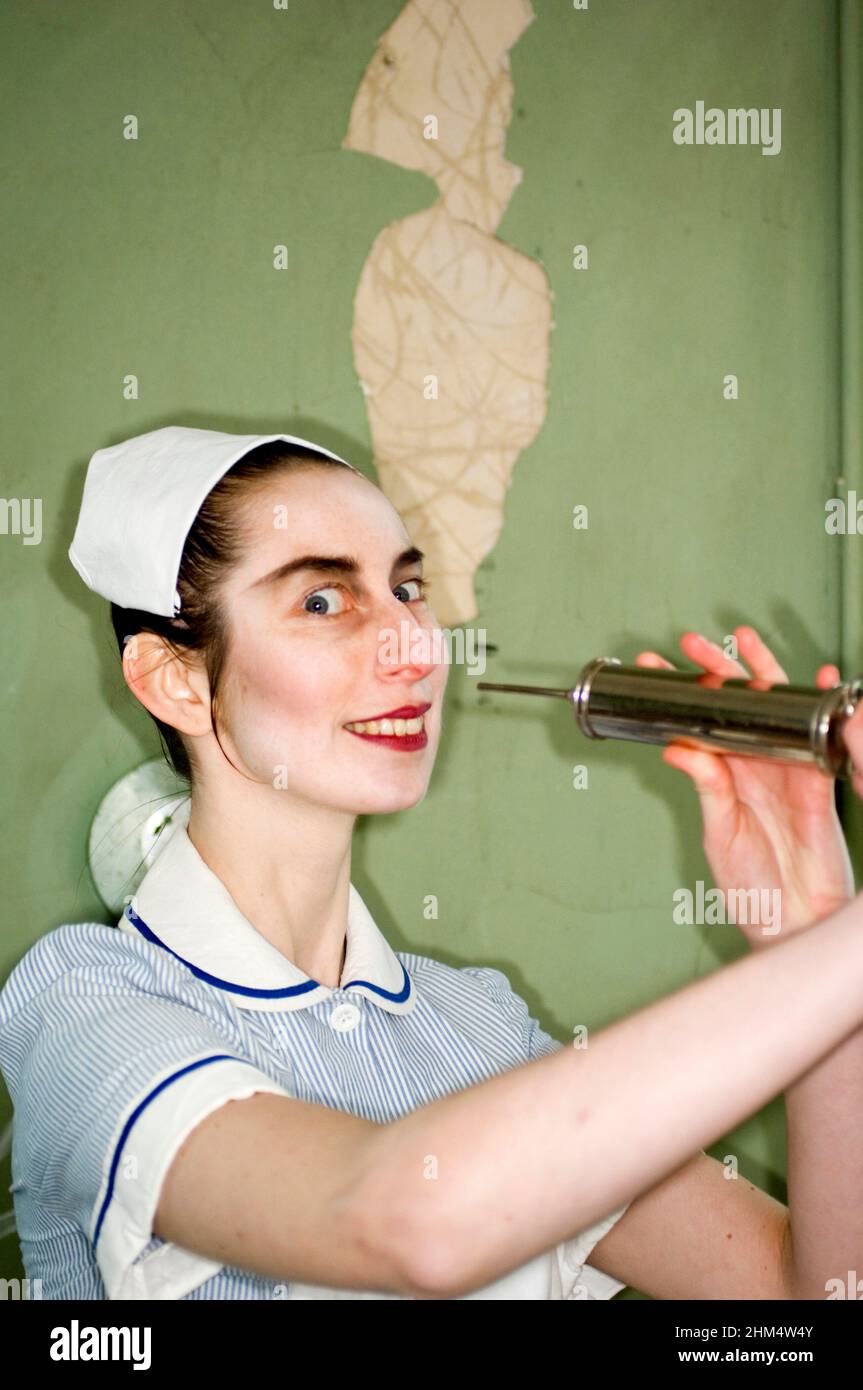 Head And Shoulders Of Stylised Nurse In Uniform, Holding Syringe., Credit:Photoshot Creative / Stuart Cox / Avalon Stock Photo