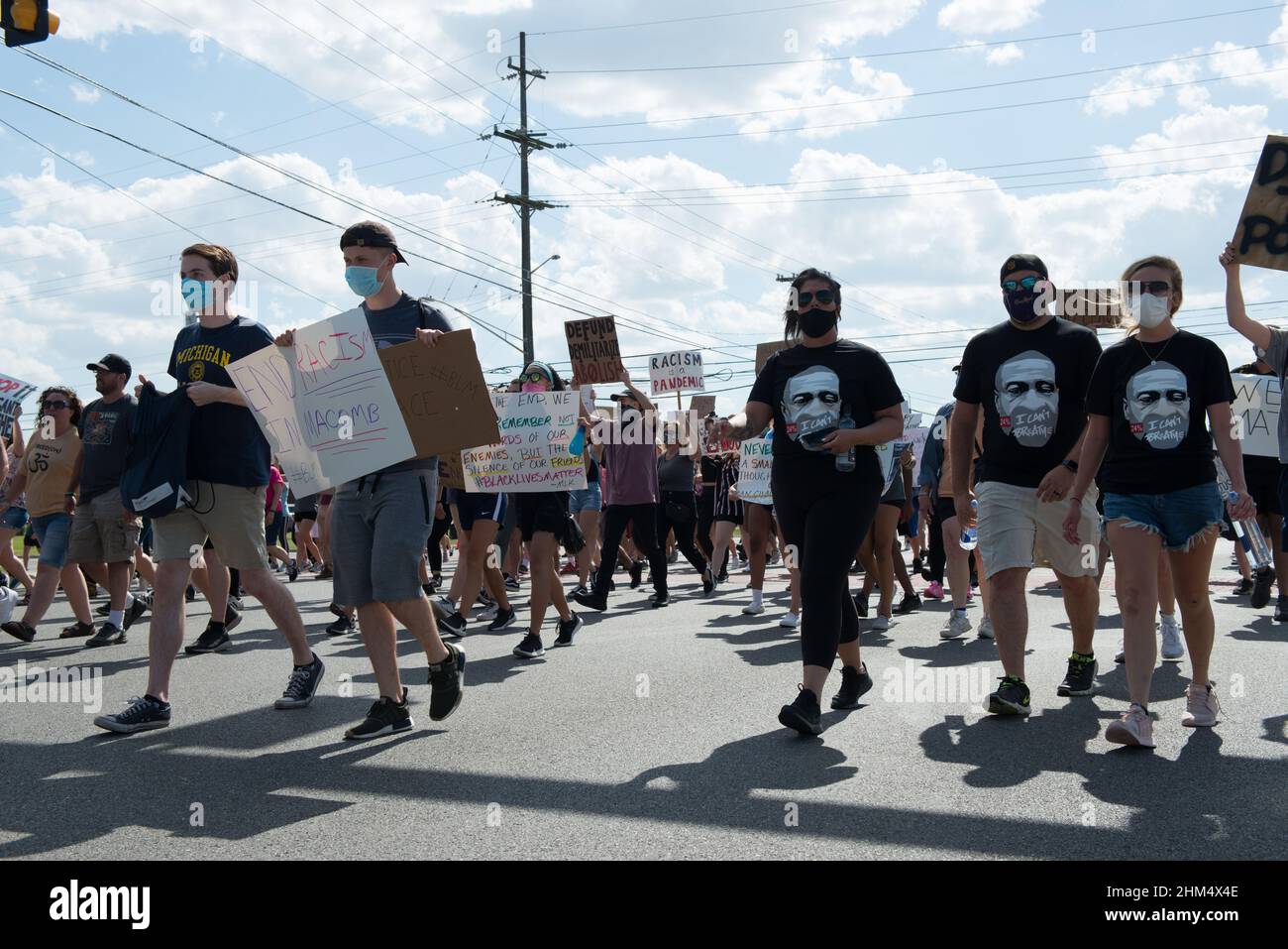 Three of the many people marching in the Black Lives Matter protest in Sterling Heights, Michigan, wearing matching George Floyd t-shirts. Stock Photo
