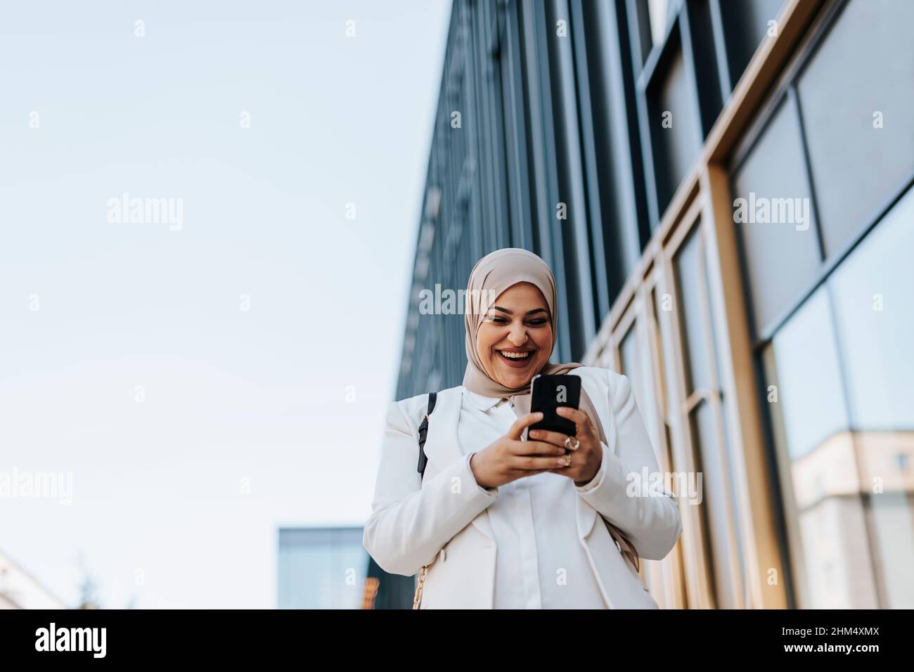 Smiling woman using cell phone Stock Photo