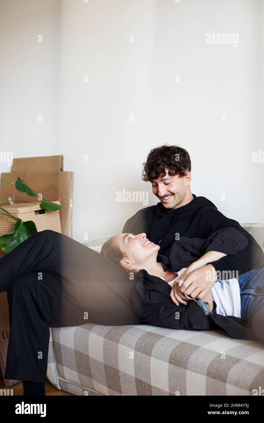 Young couple sitting on sofa Stock Photo