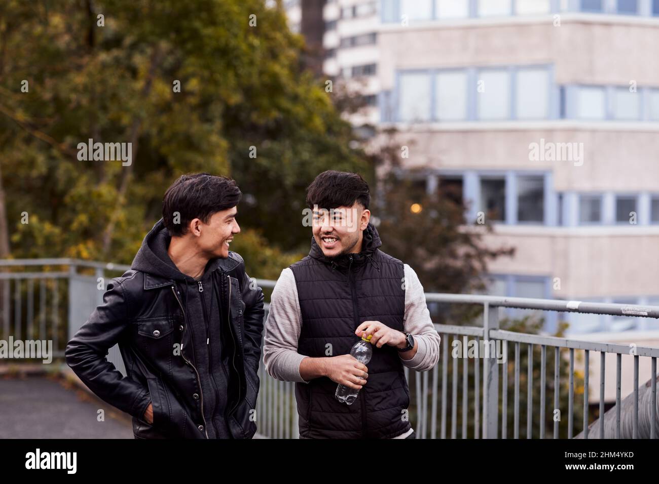 Male friends talking together Stock Photo