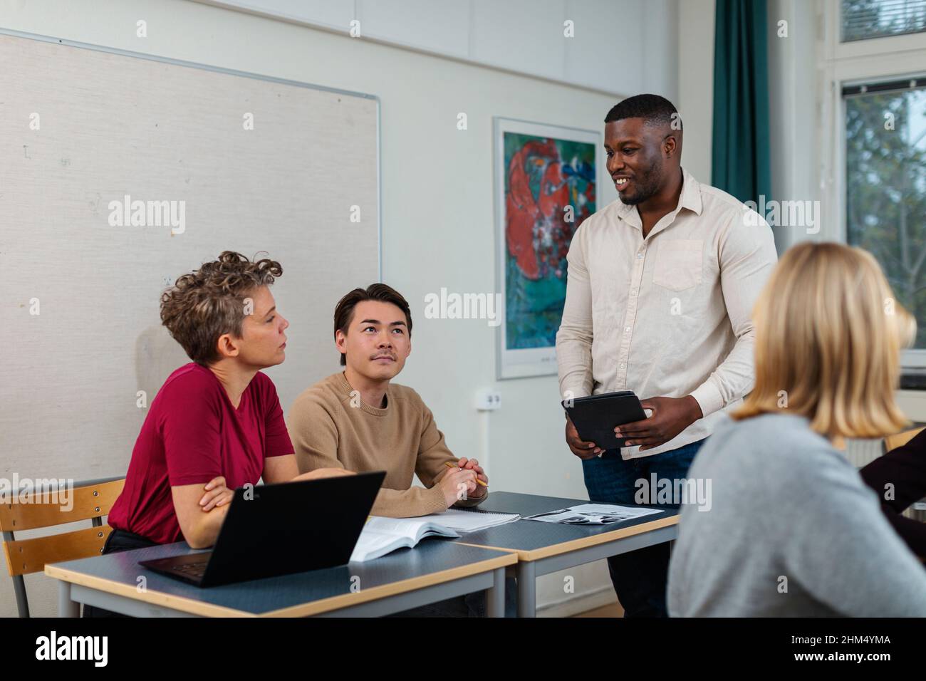 Male teacher helping student Stock Photo - Alamy