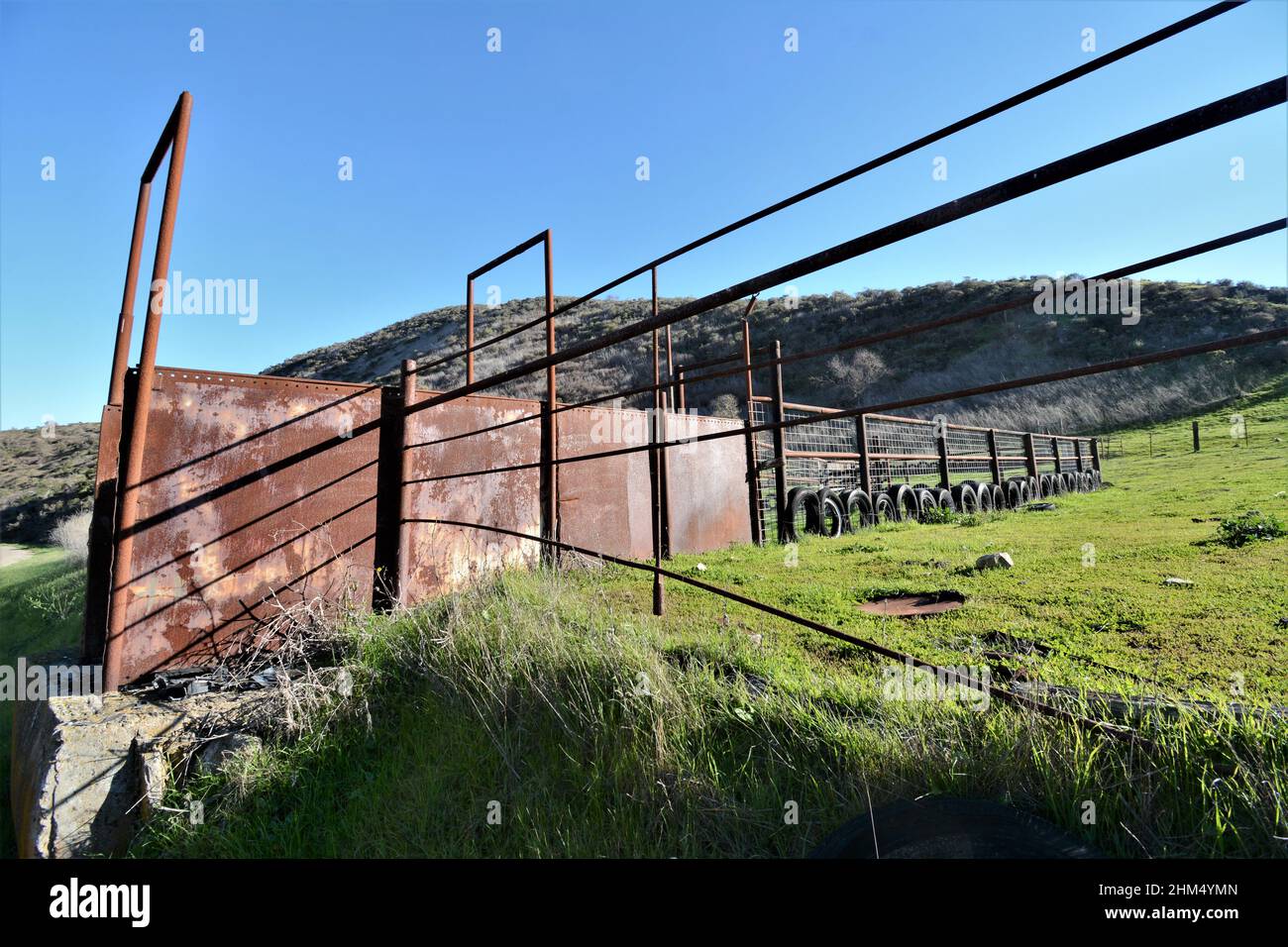 Cattle fencing on ranch made from Oil pumping pipe and old worn tires to control beef cattle for