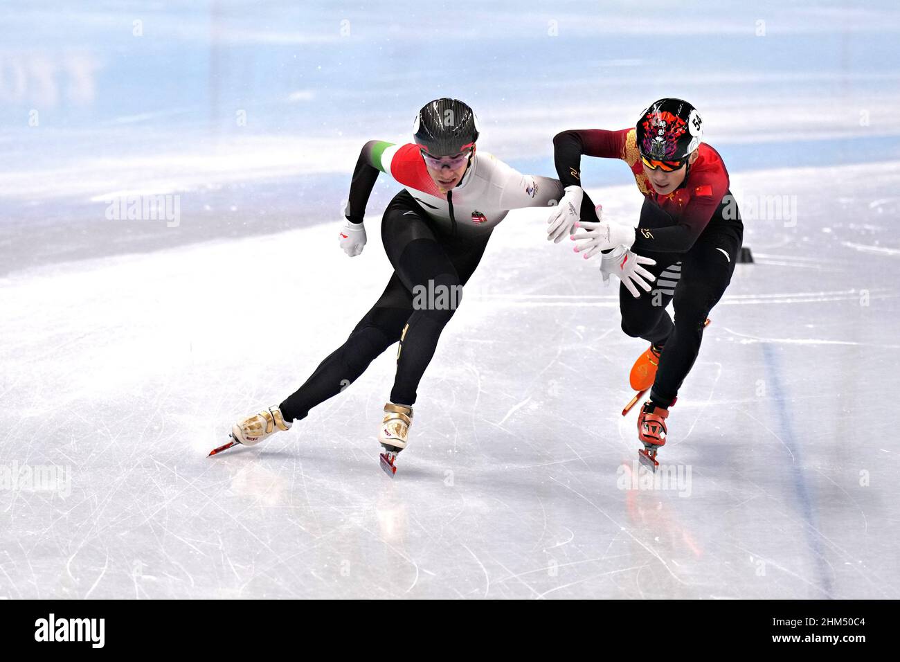 Beijing, China. 07th Feb, 2022. Ziwei Ren of China, right, blocks Shaolin Sandor Liu of Hungary during the Men's 1000m Short Track Speed Skating finals in the Capital Indoor Stadium at the Beijing 2022 Winter Olympics on Monday, February 7, 2022. Liu was penalized losing his first place finish. Photo by Richard Ellis/UPI Credit: UPI/Alamy Live News Stock Photo