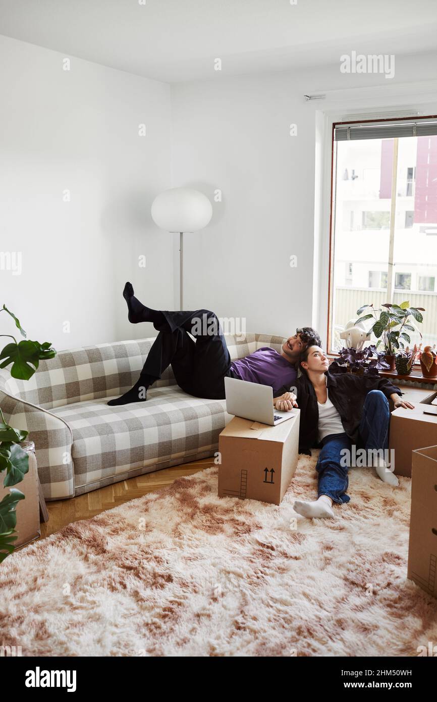 Young couple sitting in living room Stock Photo