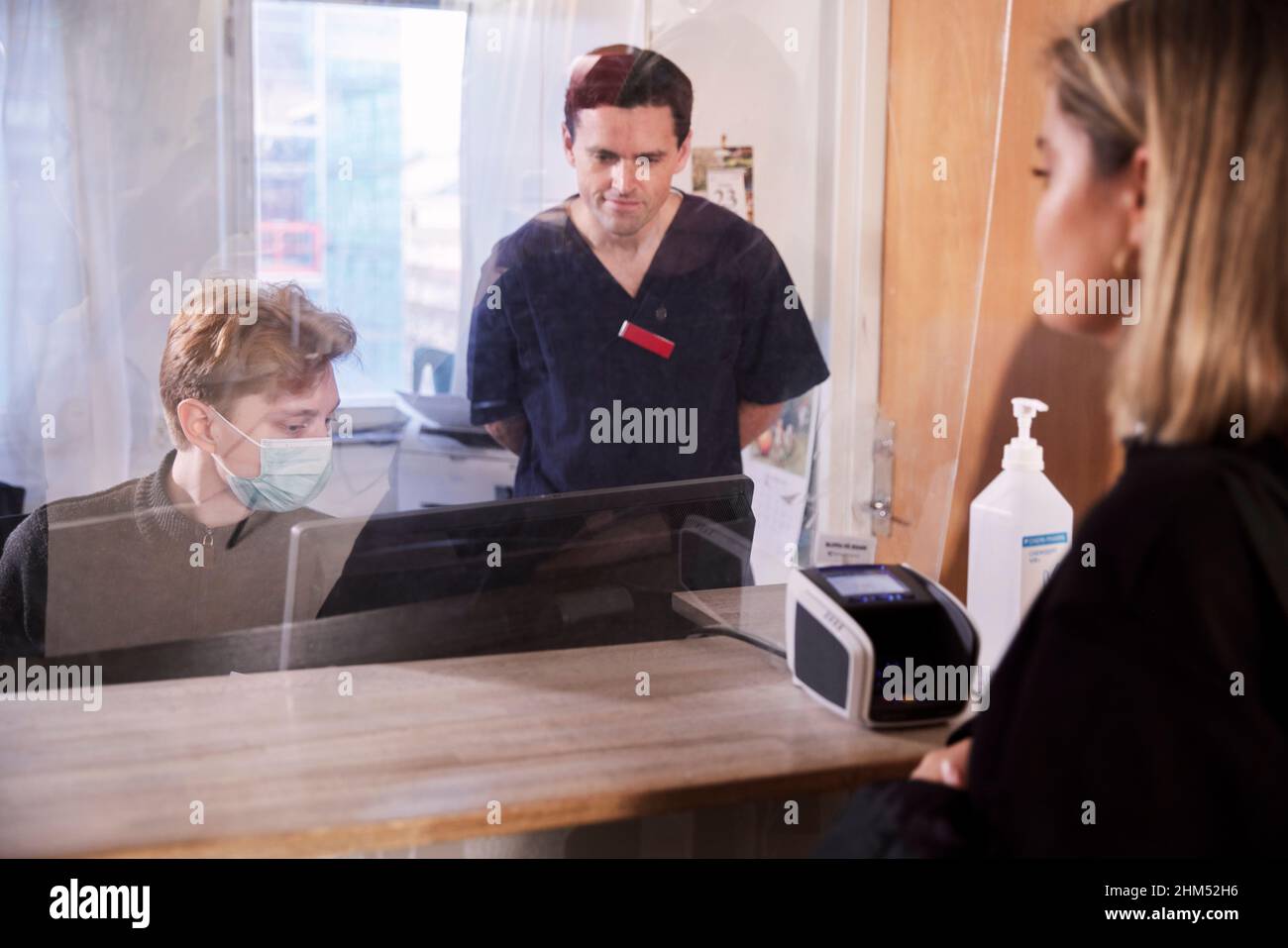 Patient and doctor at reception desk Stock Photo